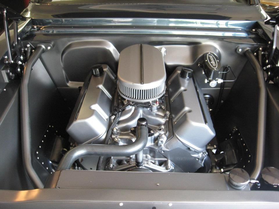 Silver engine in a black car engine bay.