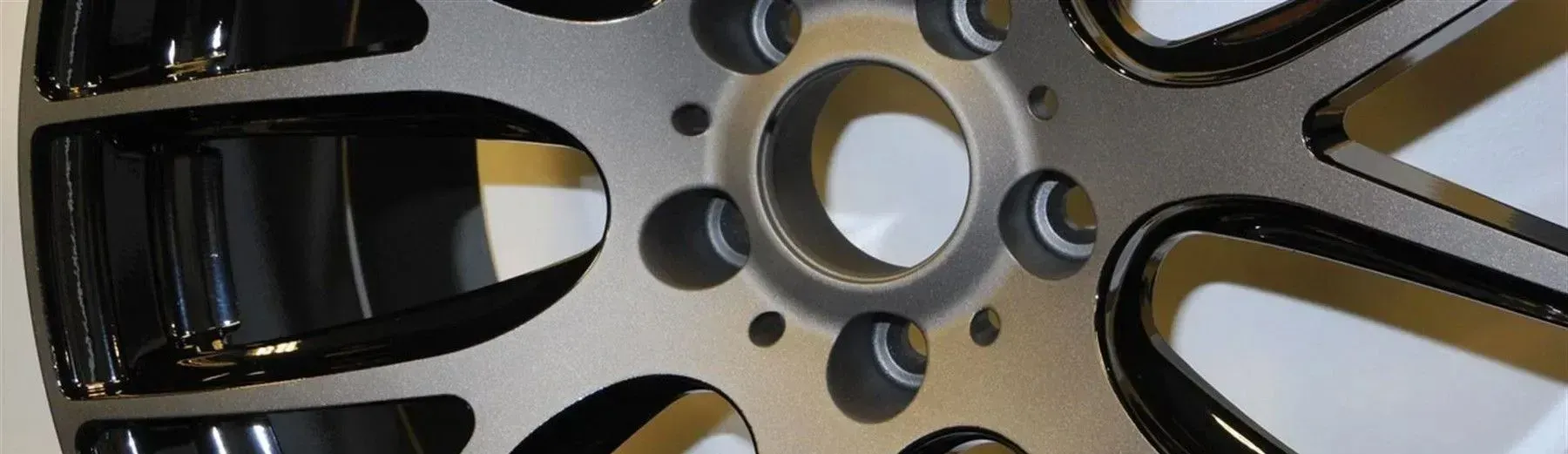 Close-up of a car wheel rim with a black and silver finish.