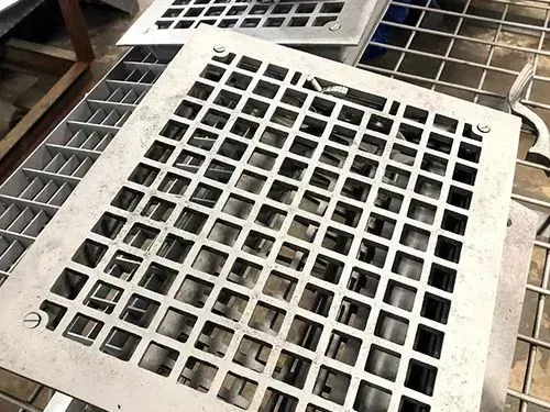 Metal ventilation grates stacked together; silver-gray color.