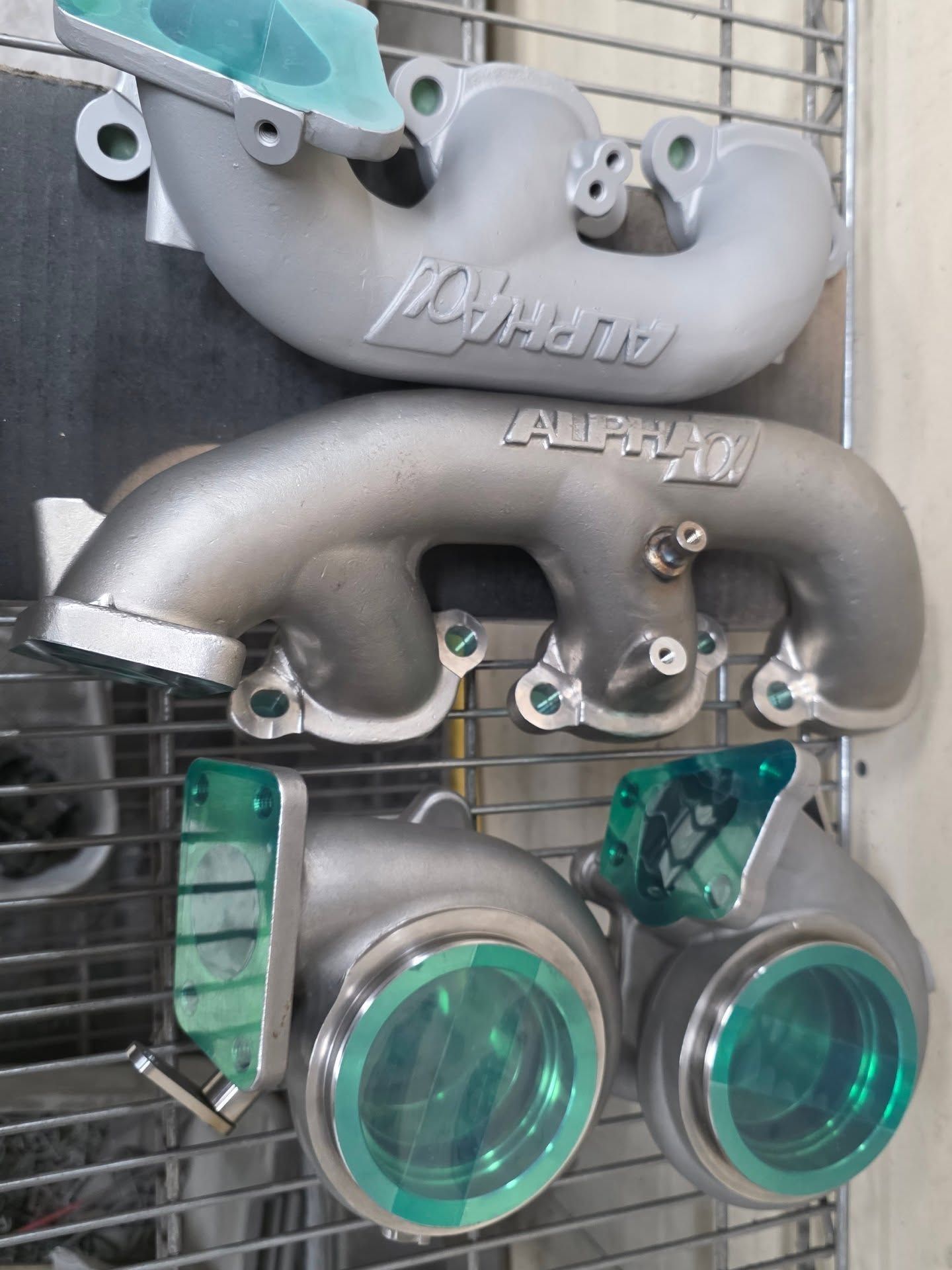 Silver metal car parts, labeled 