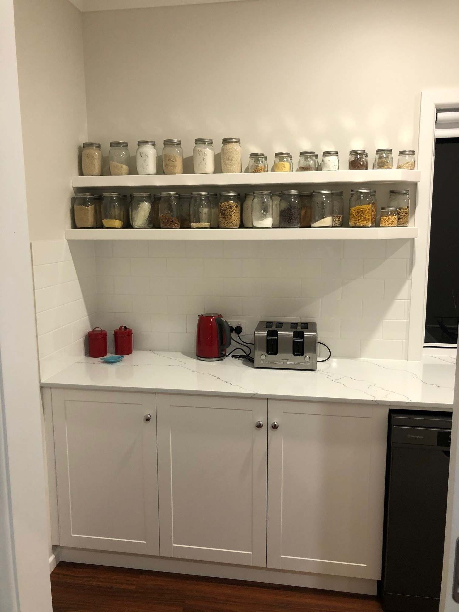 A Kitchen With White Cabinets and White counter top — Crispin Cabinetmakers in Iluka, NSW
