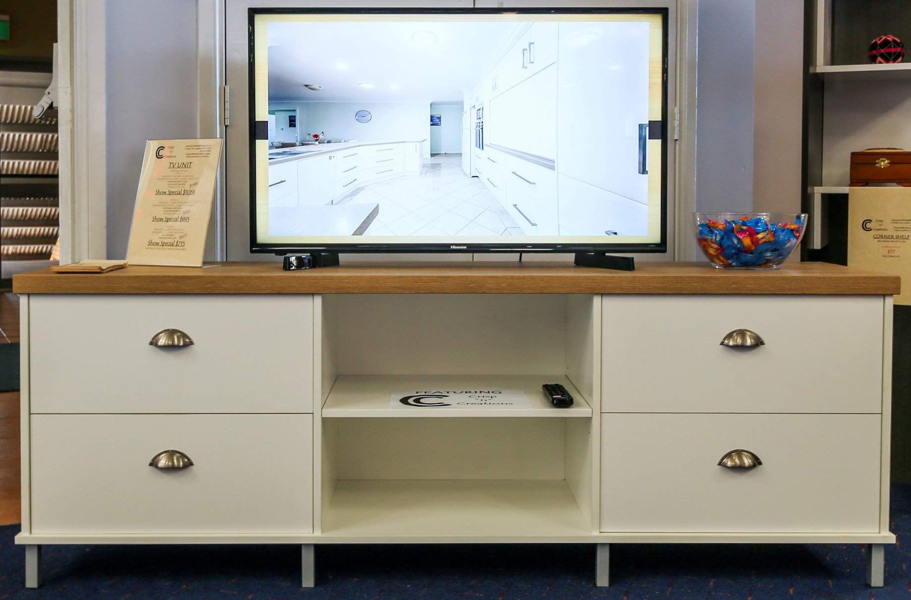 A Flat Screen Tv is Sitting on Top of a White Cabinet — Crispin Cabinetmakers in Maclean, NSW