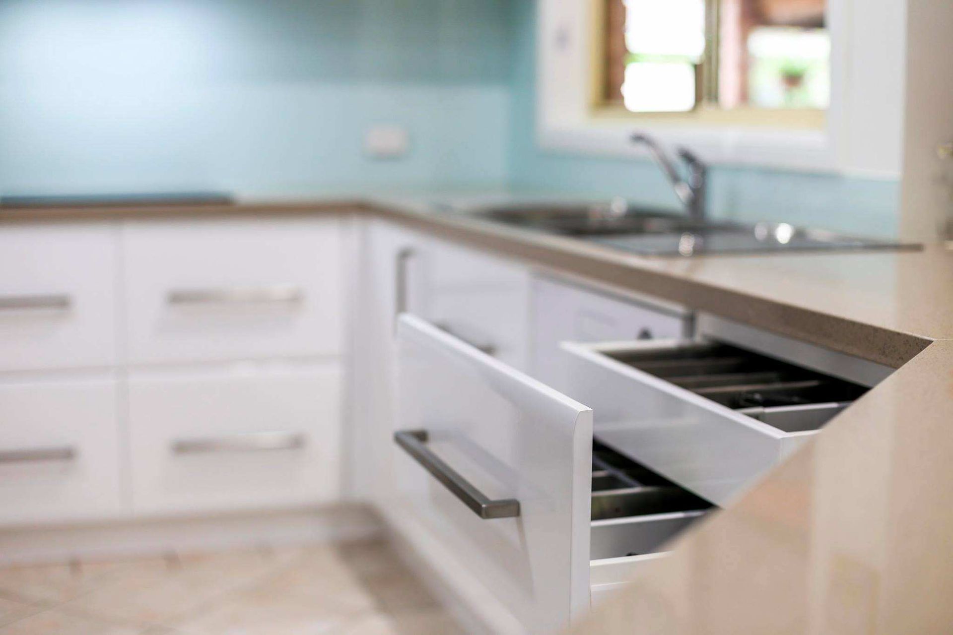A Kitchen With White Cabinets and a Drawer Open — Crispin Cabinetmakers in Iluka, NSW