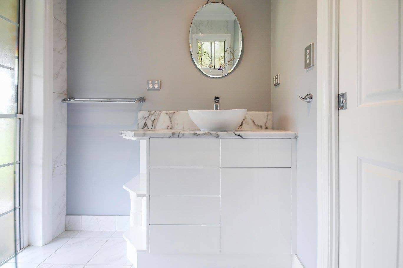 A Bathroom With a Sink, Mirror and Cabinets — Crispin Cabinetmakers in Yamba, NSW