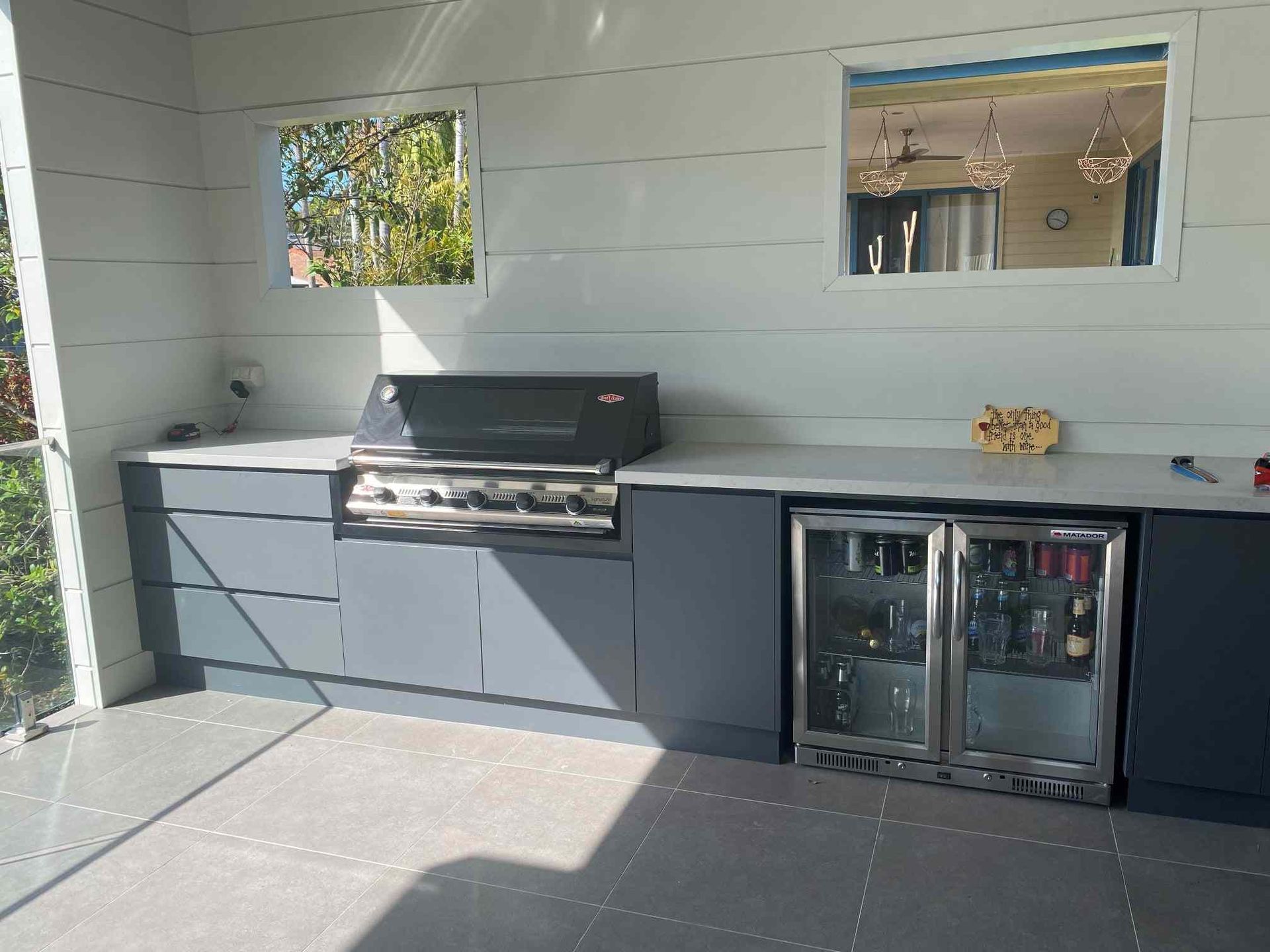 A Kitchen With a Grill and a Refrigerator — Crispin Cabinetmakers in Yamba, NSW