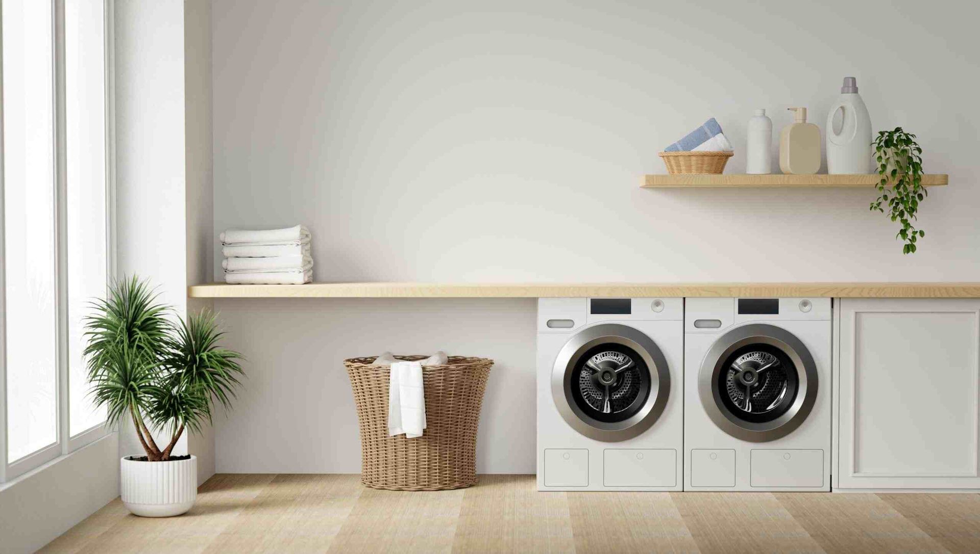 A Laundry Room With a Washer and Dryer and a Wicker Basket — Crispin Cabinetmakers in Iluka, NSW