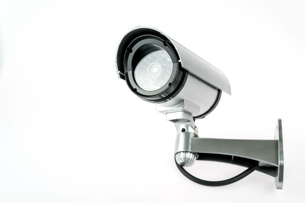 A Security Camera is Mounted to a Wall on a White Background — Darwin Lock & Key In Rural Darwin, NT