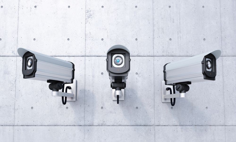 Three Security Cameras Are Mounted on a Concrete Wall — Darwin Lock & Key In Coolalinga, NT