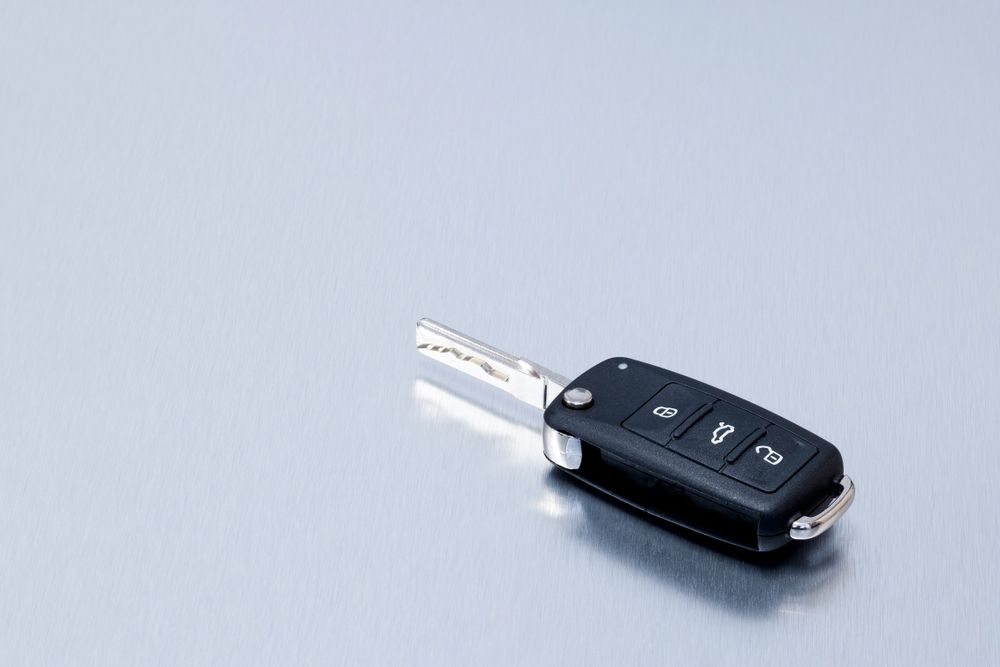 A Car Key is Sitting on a Gray Surface — Darwin Lock & Key In Casuarina, NT