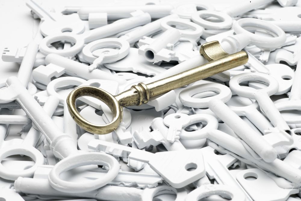 A Pile of White Keys With a Gold Key in the Middle — Darwin Lock & Key In Howard Springs, NT
