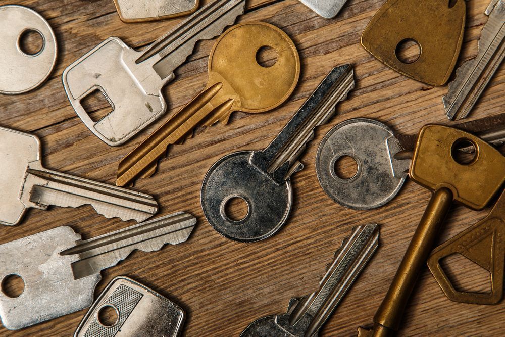 A Bunch of Keys Are Laying on a Wooden Table — Darwin Lock & Key In Pinelands, NT