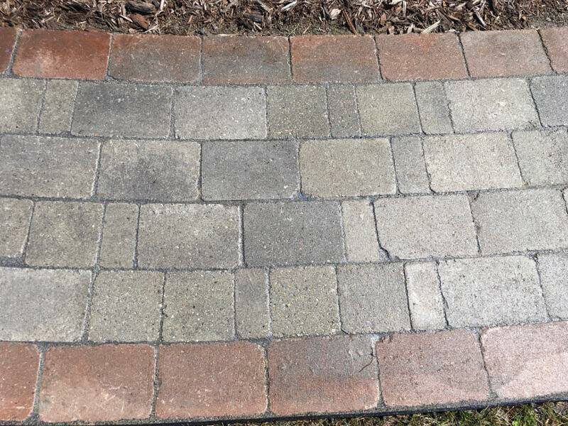 A walkway made of bricks with a brick border