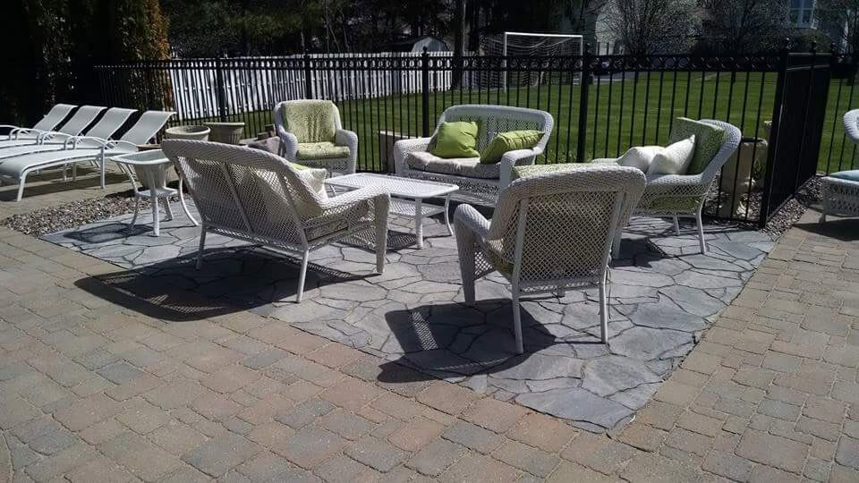A patio with a lot of chairs and a table