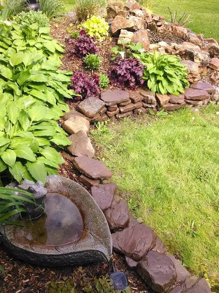 There is a fountain in the middle of the garden.