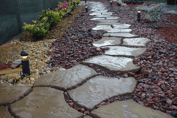 A stone walkway surrounded by rocks and plants