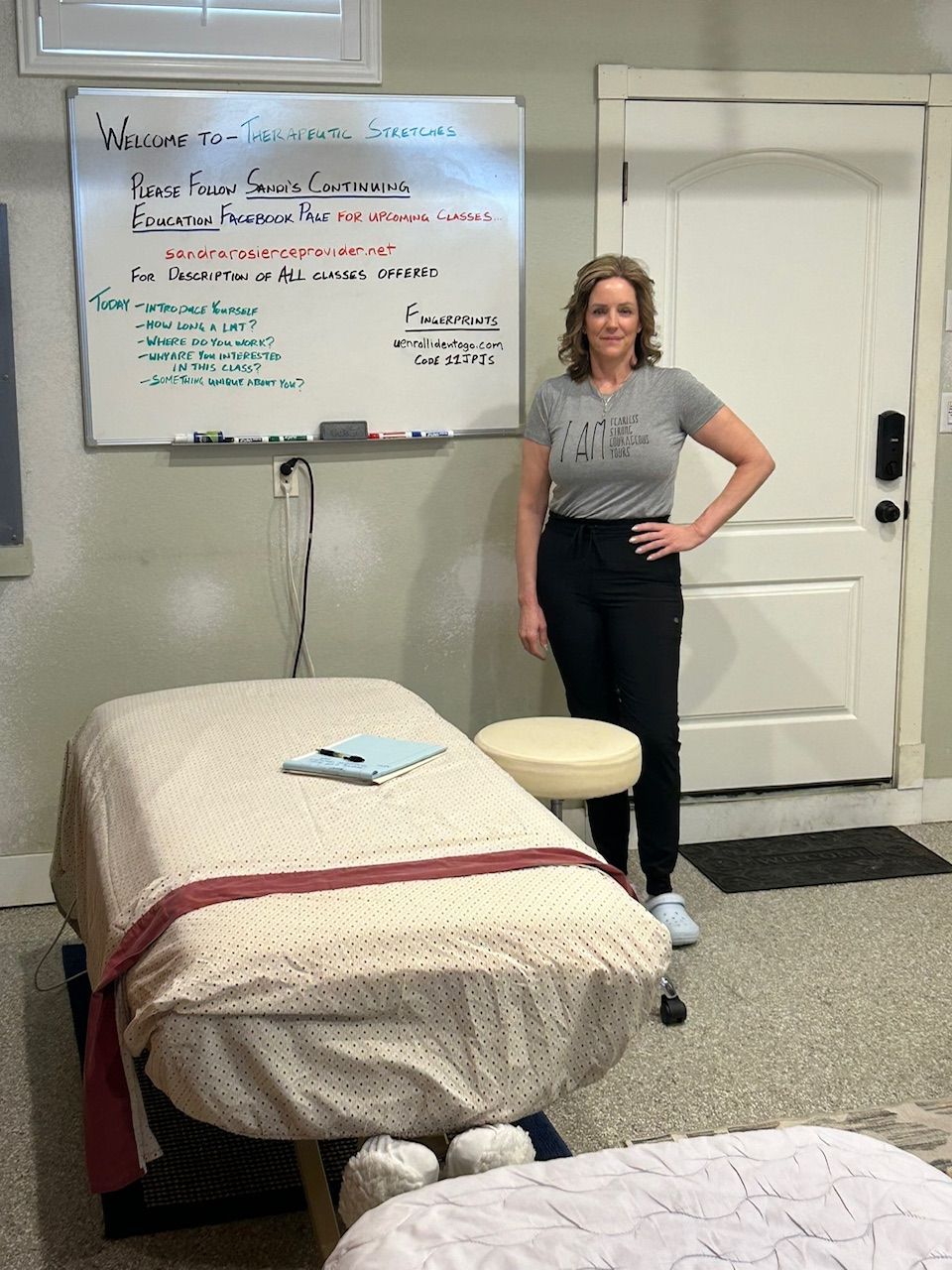 Sandi Rosier standing in her massage studio classroom