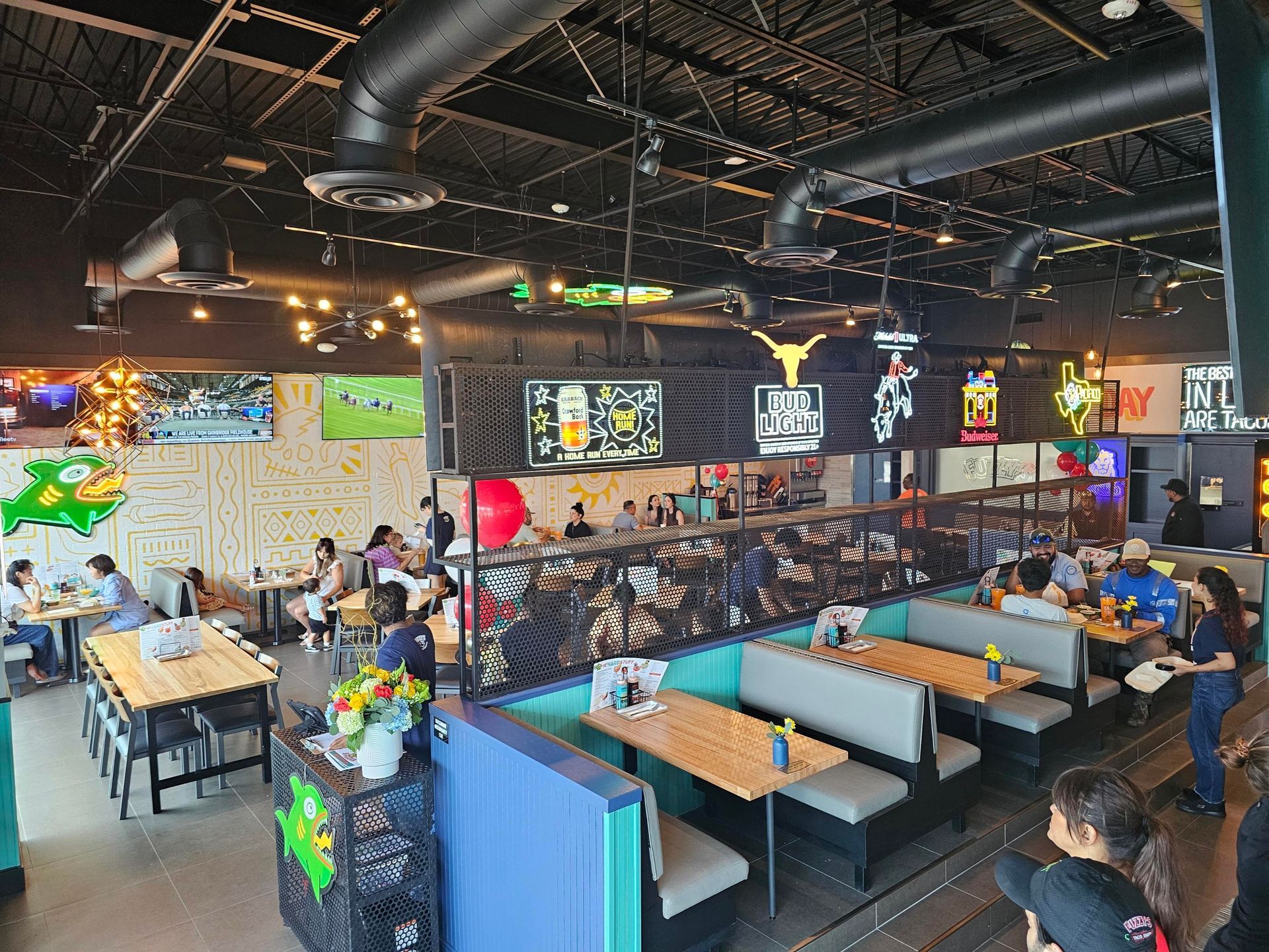 interior view of NGE-franchised Fuzzy's Tacos in Sugar Land Texas with diners and staff