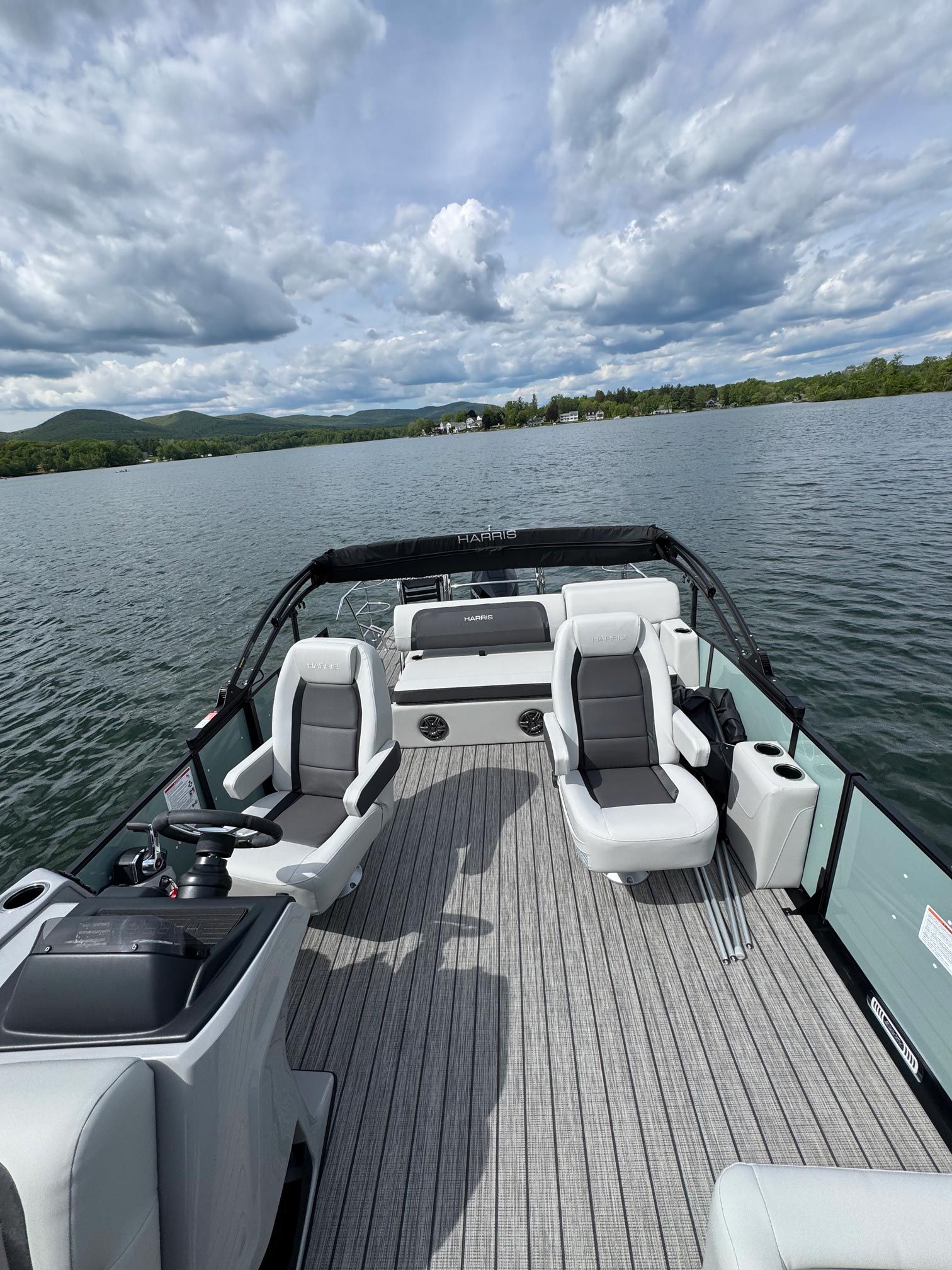 A pontoon boat is floating on top of a lake.