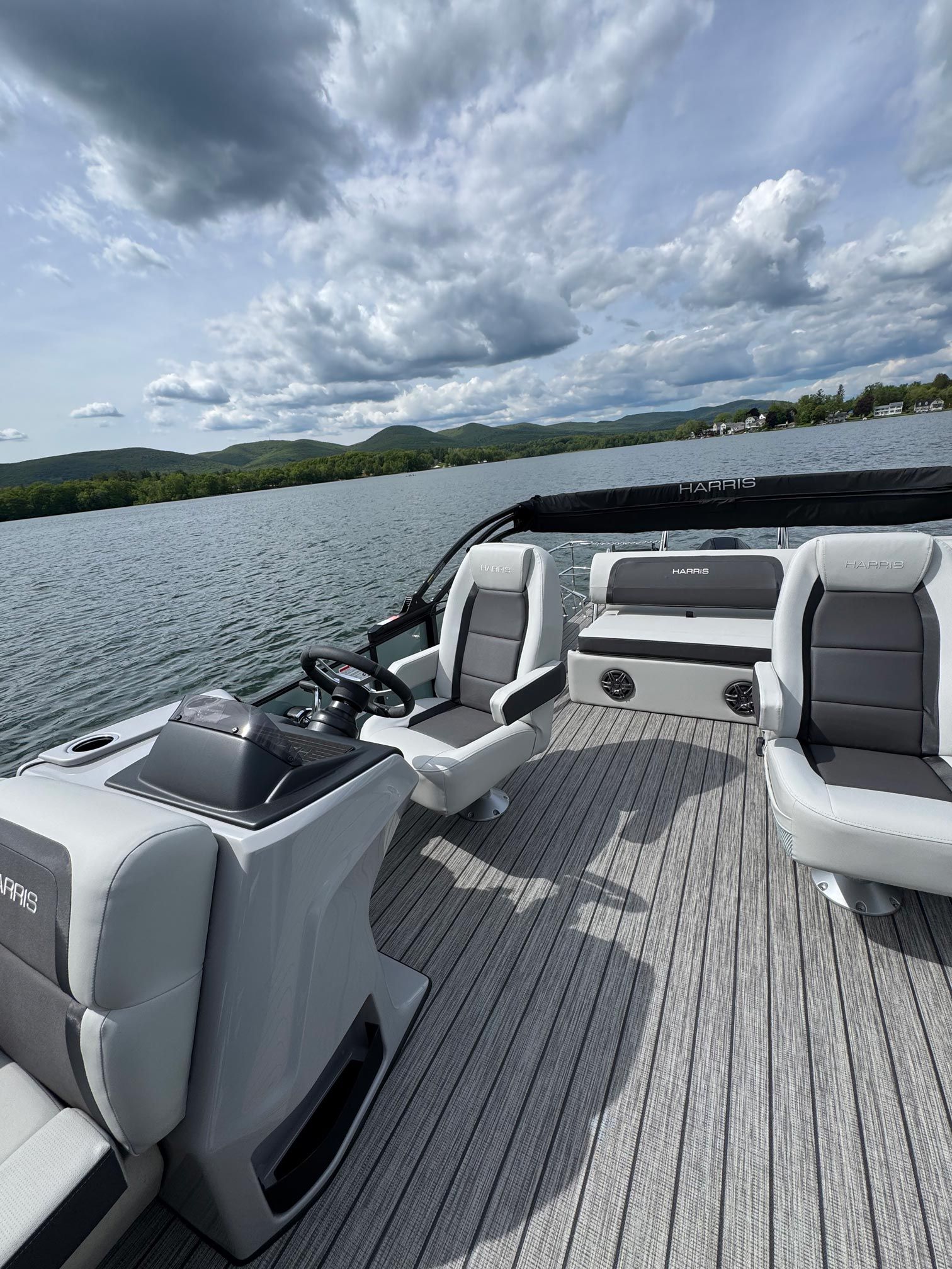 A pontoon boat is floating on top of a lake.
