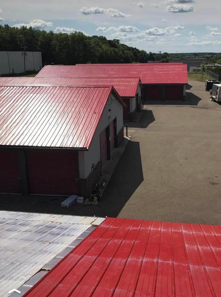 A row of buildings with red roofs in a parking lot