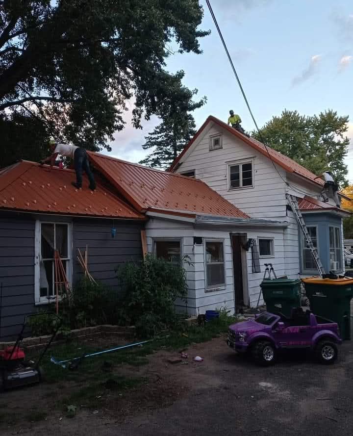 A purple toy car is parked in front of a house