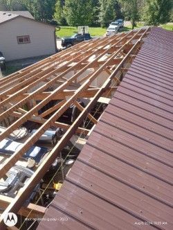 The roof of a building is being built with wooden beams.