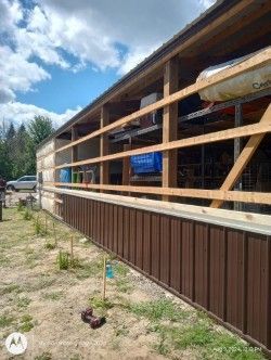 A building with a fence around it and a lot of kayaks in it.