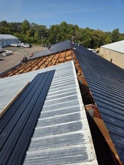 A metal roof is being built on top of a building.