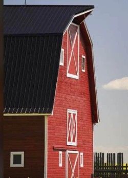 A red barn with a black roof and white doors