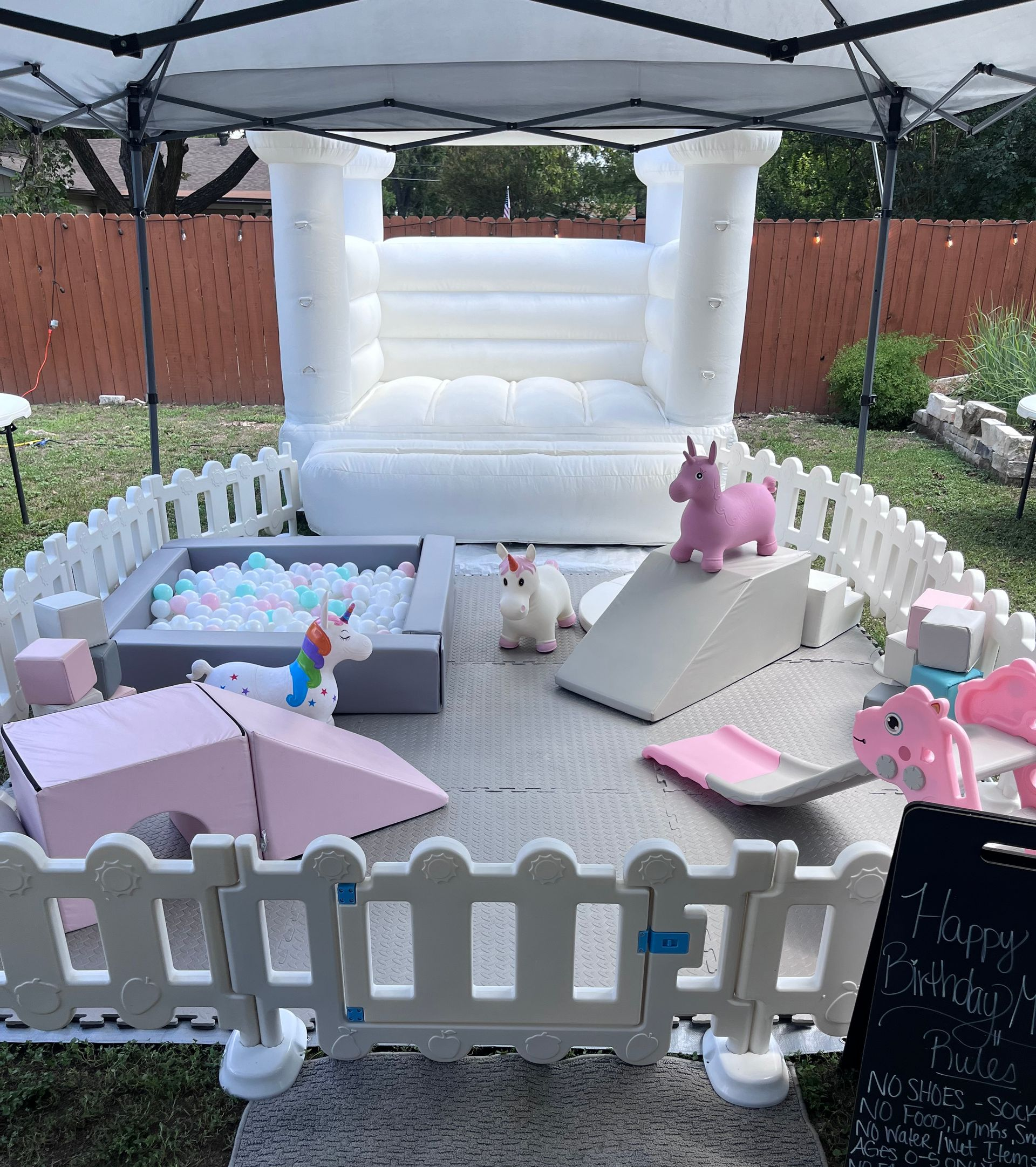 There is a bouncy castle and a ball pit in the backyard.