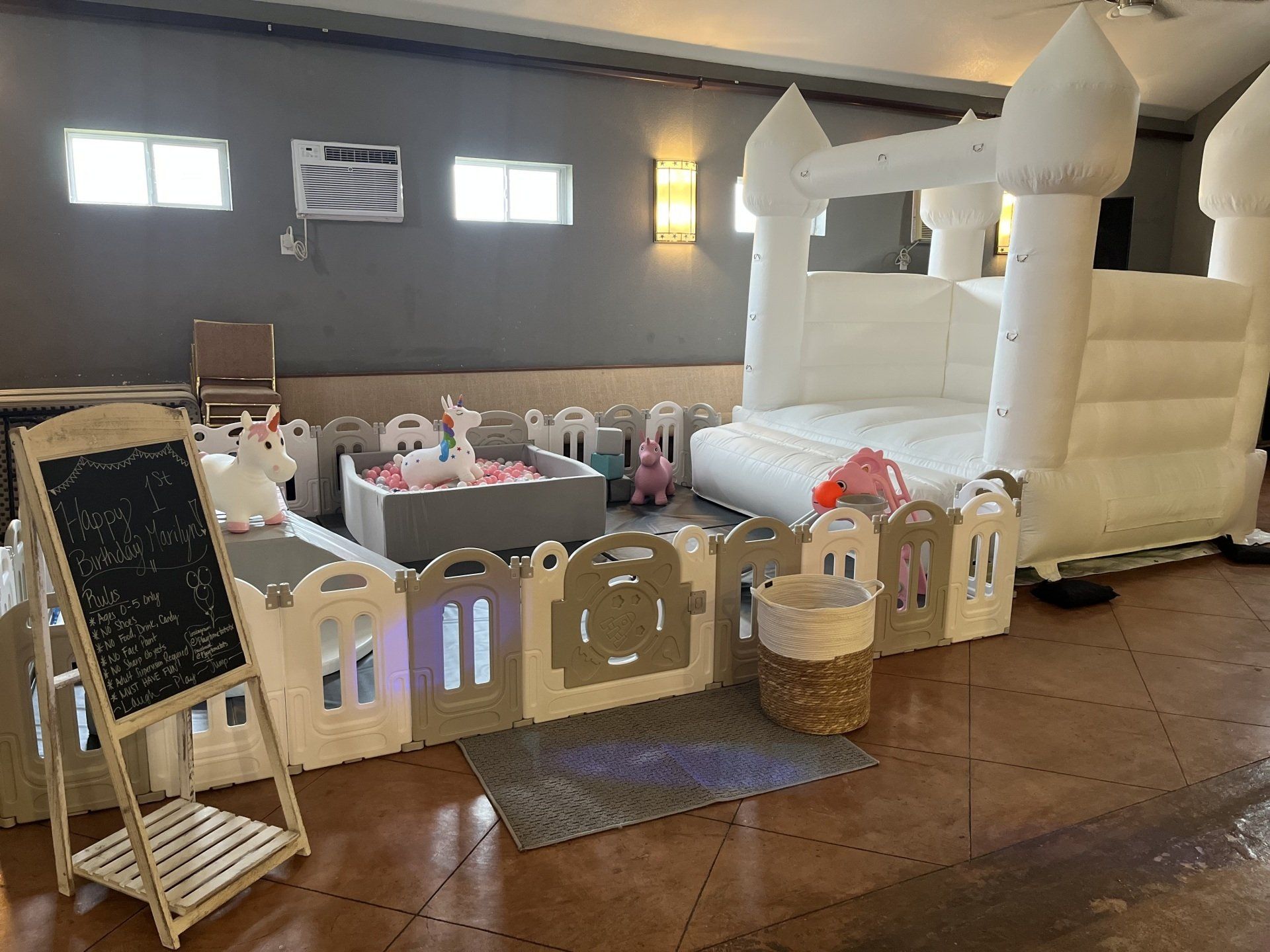 There is a white bouncy castle in the middle of the room.