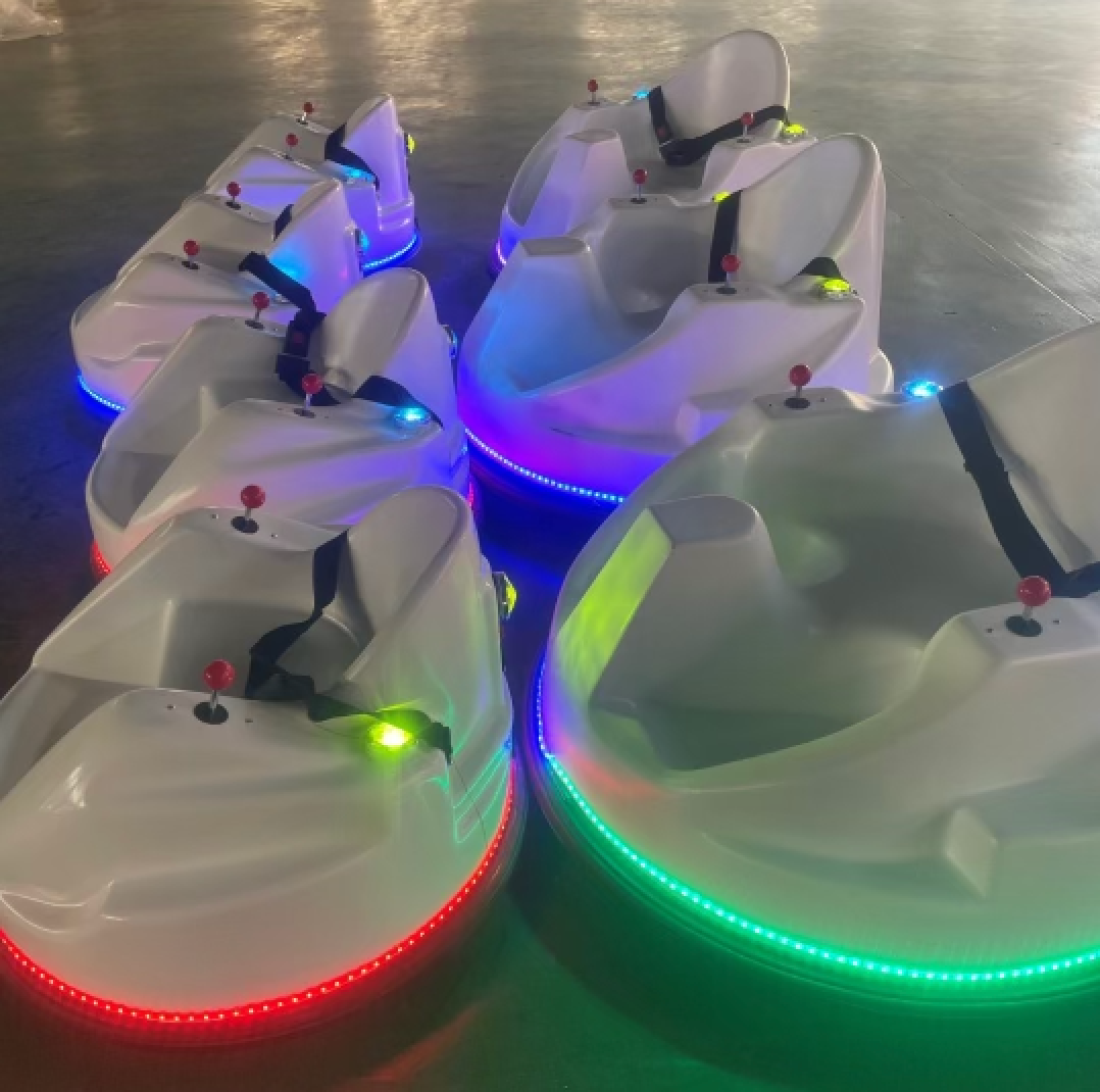 A bunch of bumper cars are lit up in different colors