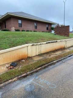 Gray wood-look flooring installed in a room with tan walls. A white cabinet is in the corner.