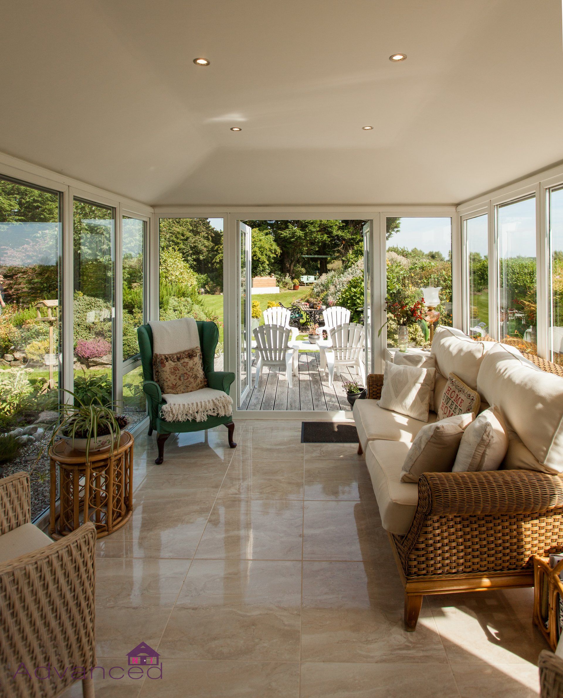 A living room with a couch , chairs and a table