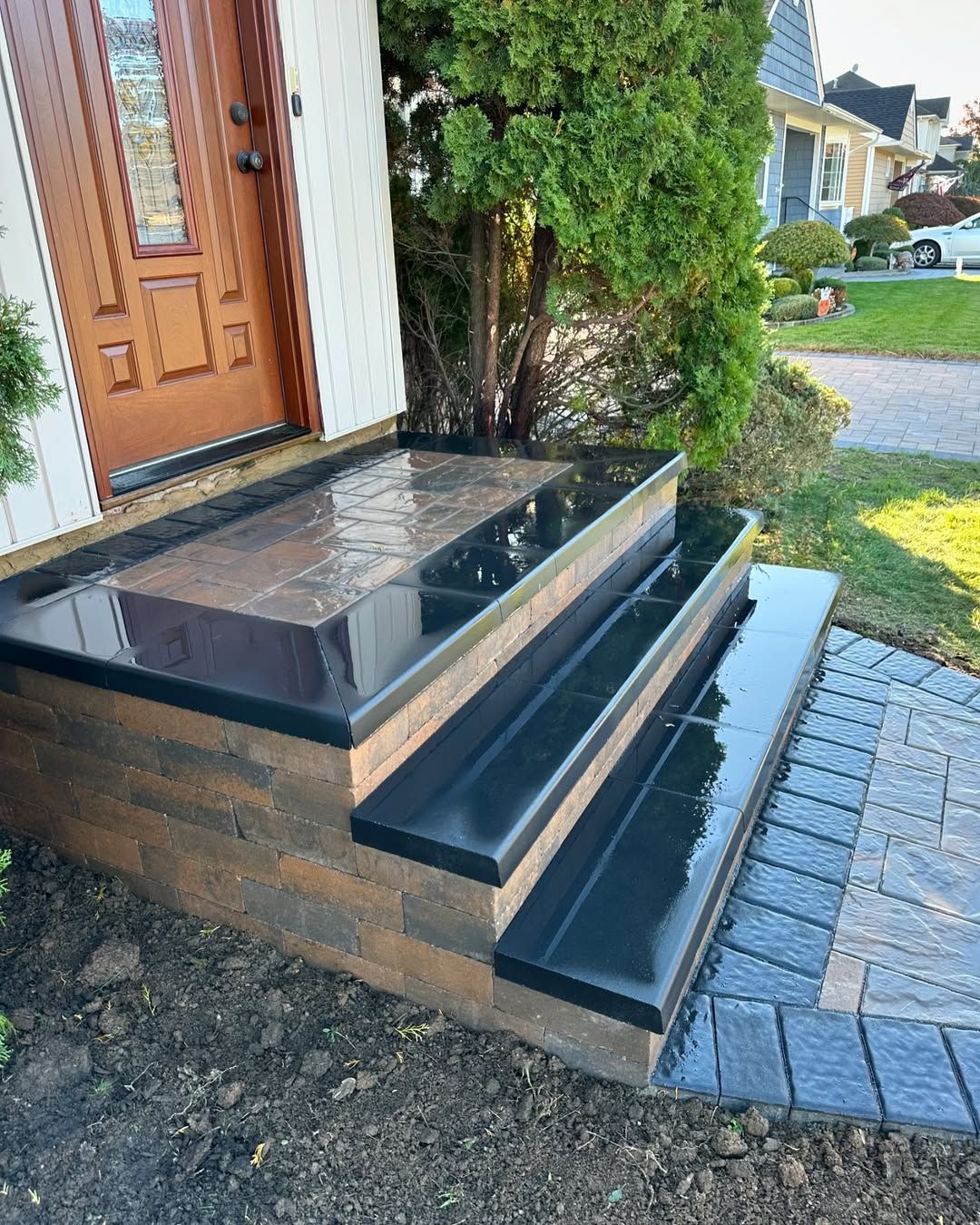 A set of stairs leading up to the front door of a house.