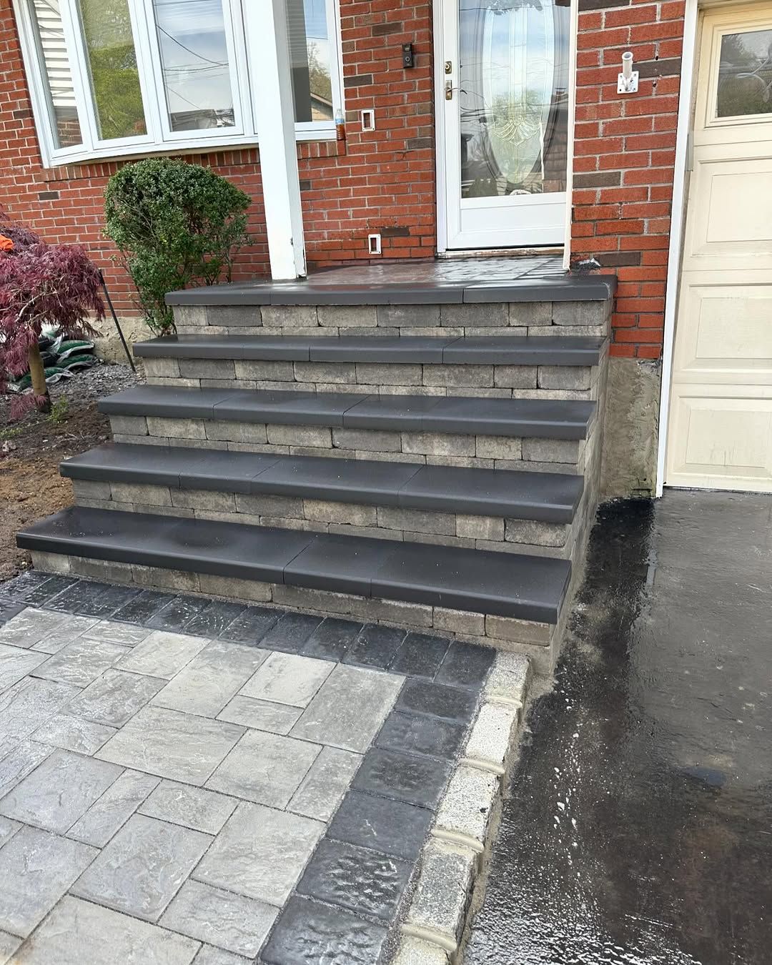A set of stairs leading up to a brick house.