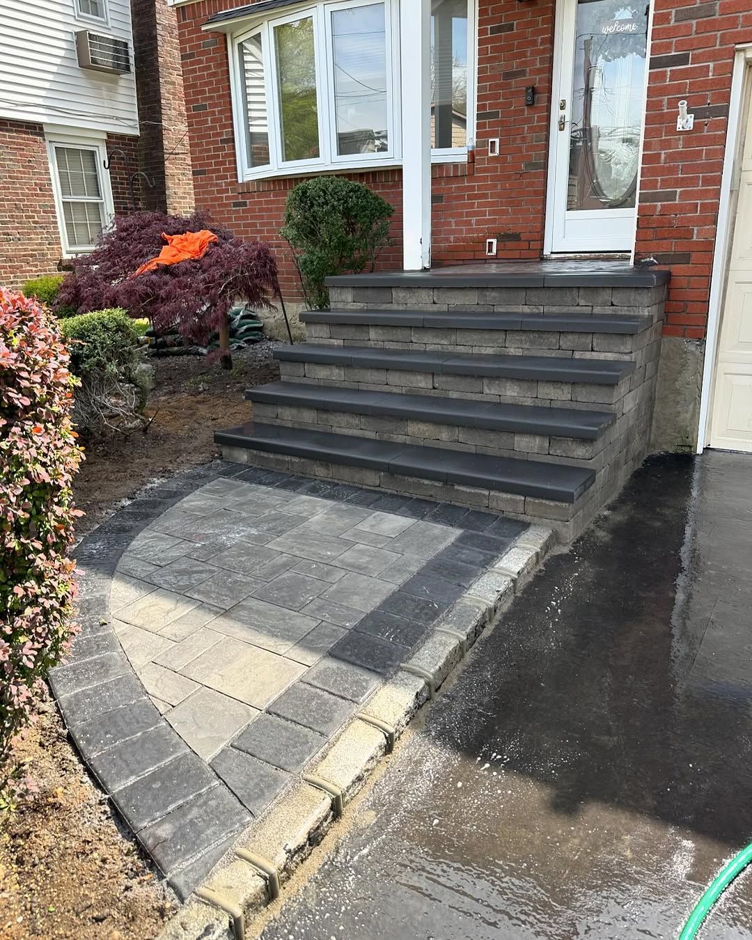 A brick house with steps leading up to the front door.