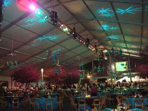 A large room with tables and chairs under a tent