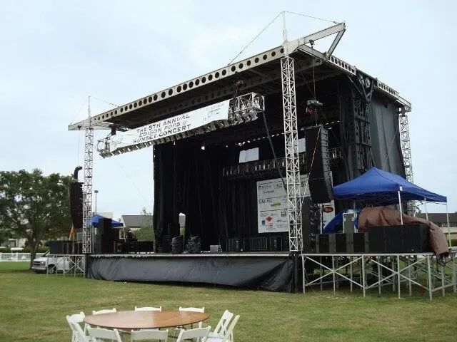 A large stage with tables and chairs in front of it