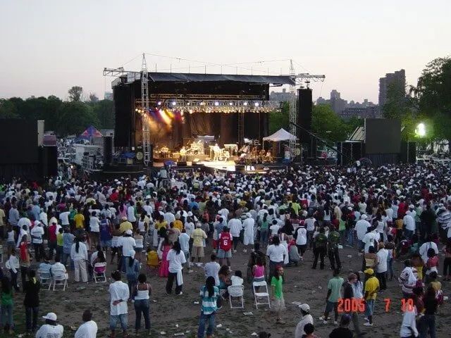 A large crowd of people are gathered in front of a stage at a concert in 2006
