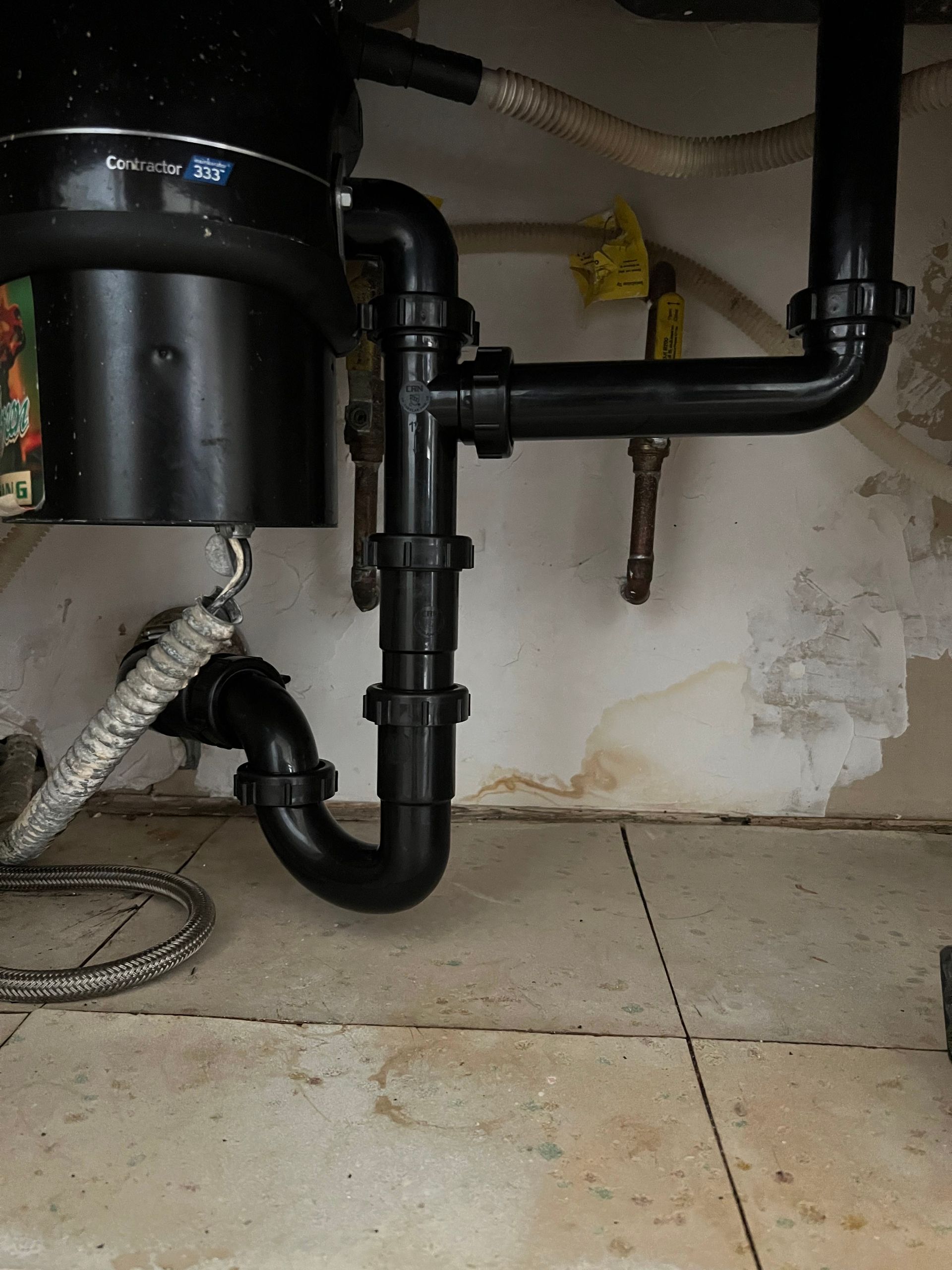 a contractor 335 garbage disposal sits under a sink