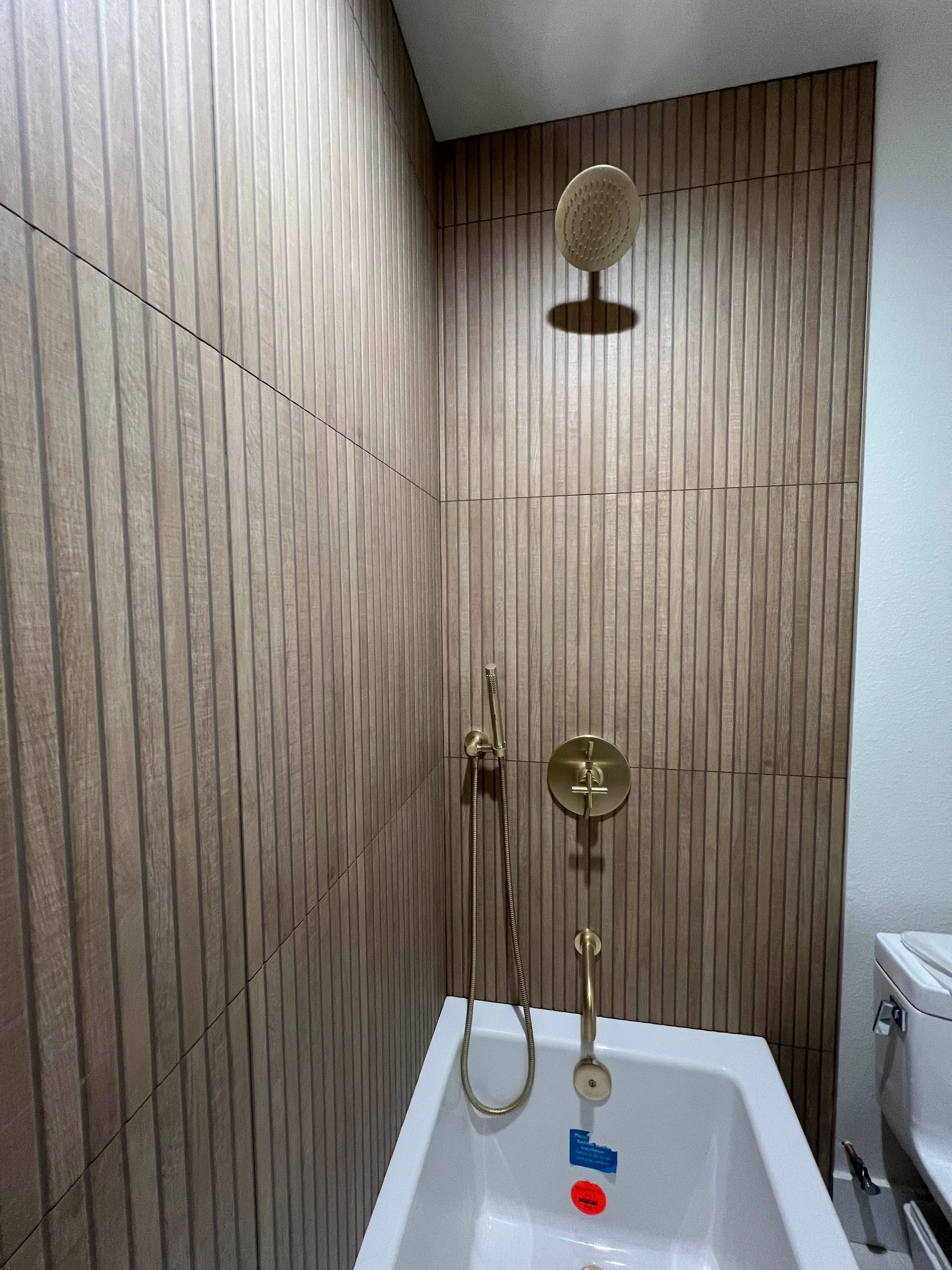 a bathroom with a bathtub and a shower head