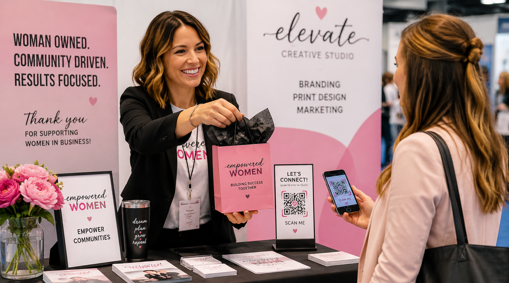 A business owner handing a branded promotional gift to a visitor of their booth at a trade show.