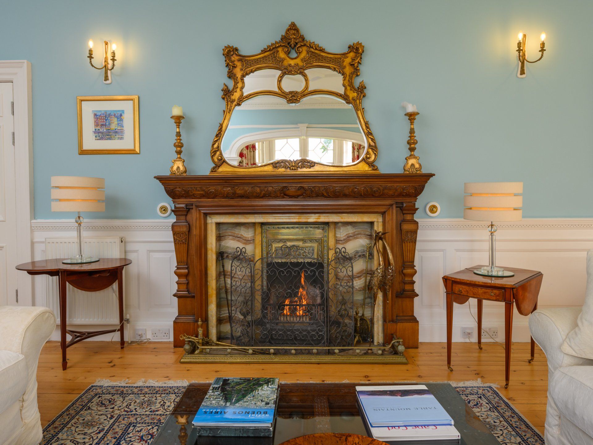 A living room with a fireplace and a mirror