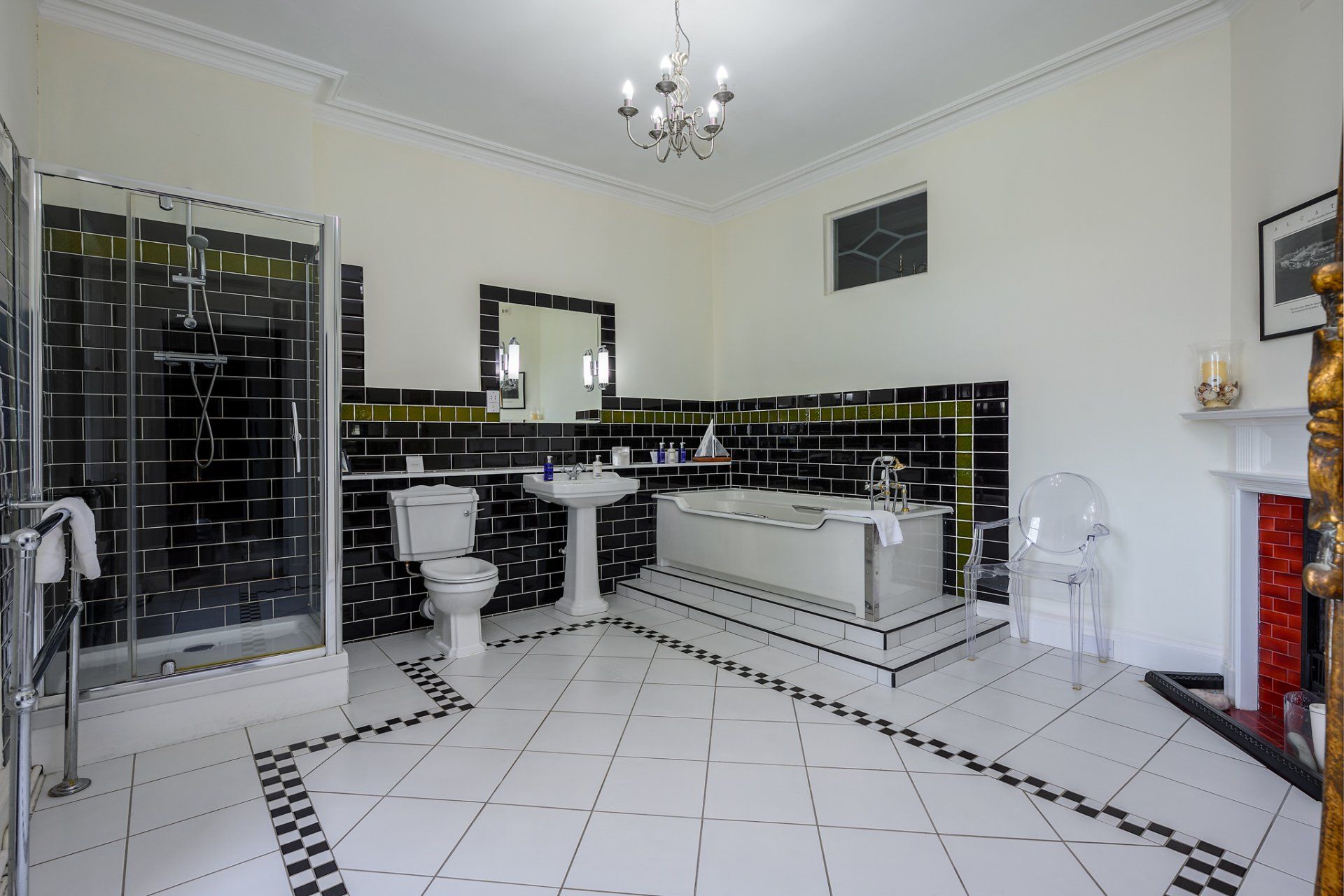 A bathroom with black and white tiles and a bathtub