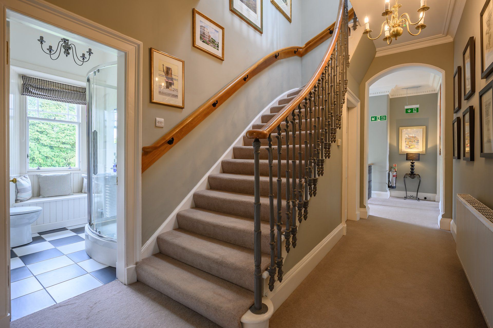 A hallway with stairs leading up to the second floor