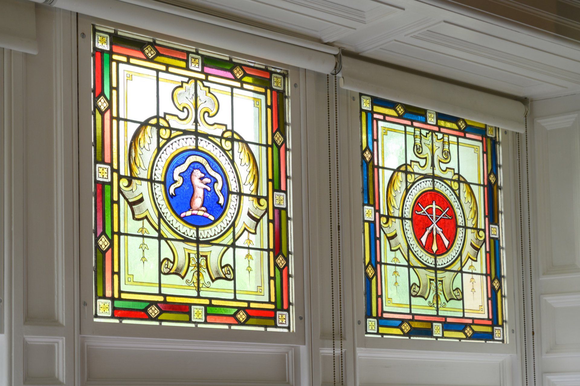 A stained glass window with a coat of arms on it