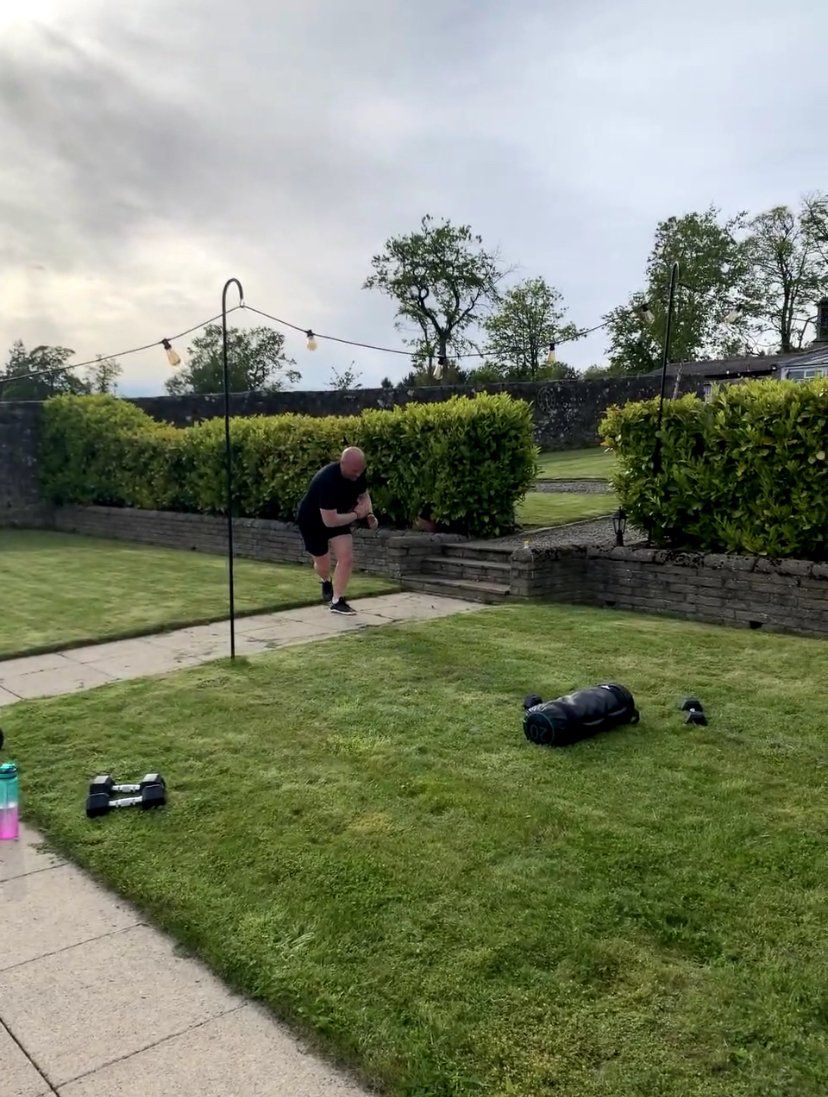 A man is running on a path in a grassy yard