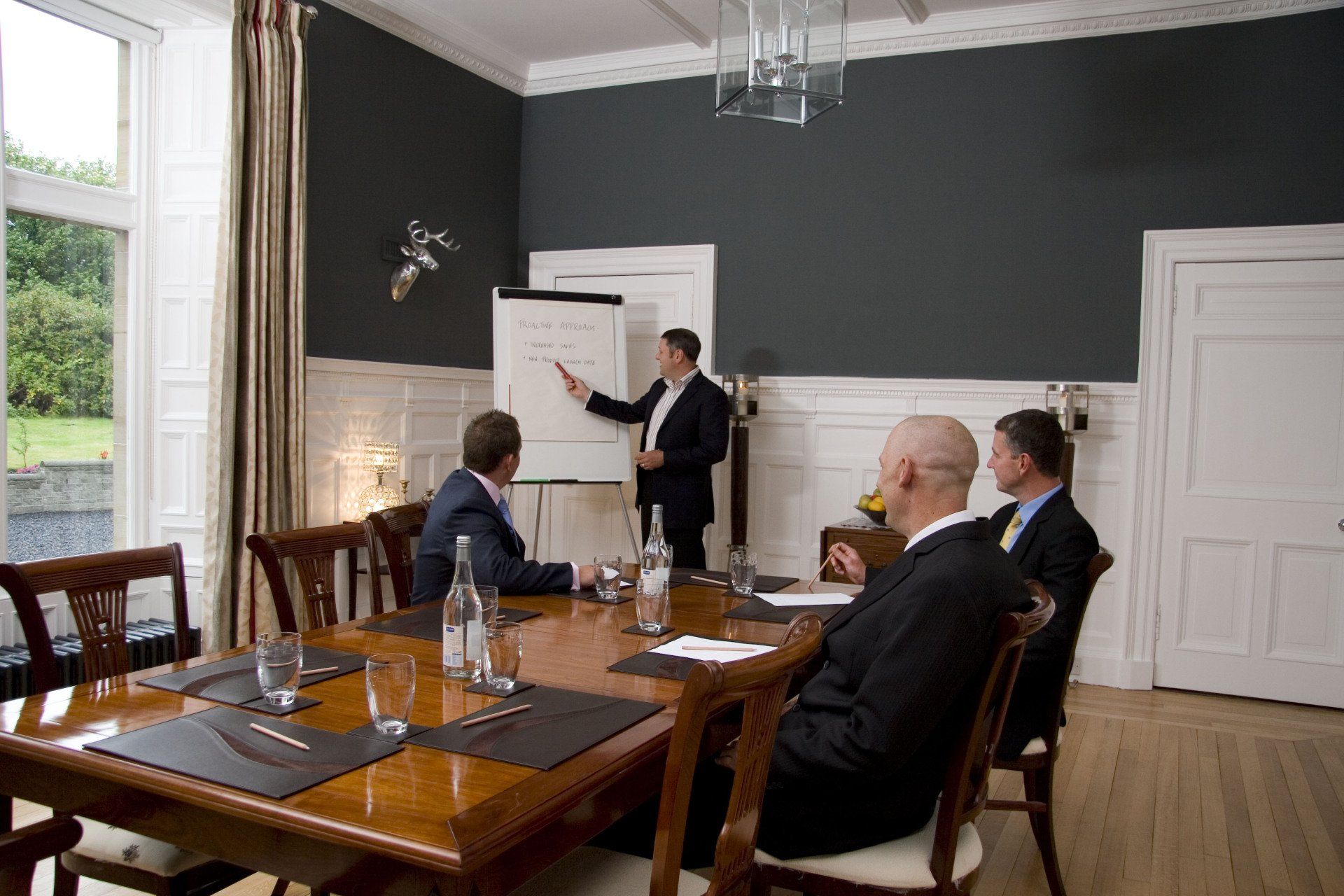 A man is giving a presentation to a group of people