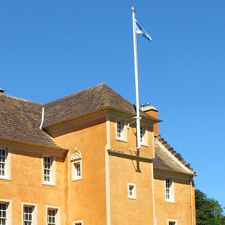 A large orange building with a flag on top of it